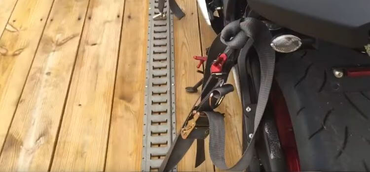 Use soft ties or straps to secure the motorcycle to the trailer or truck bed.