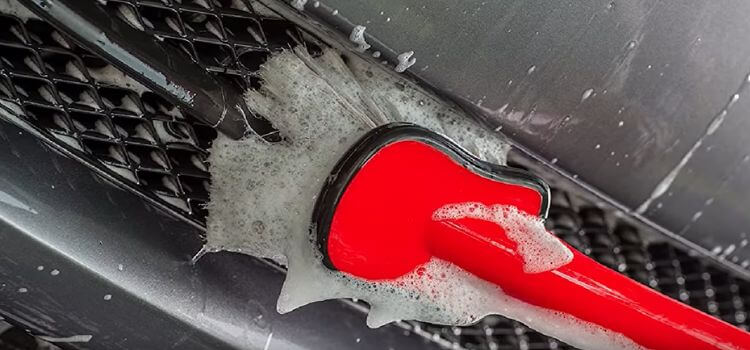 The advantage of using a foam brush for cleaning a car.
