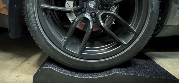 Use tire cradles or stands to distribute the weight of the car.