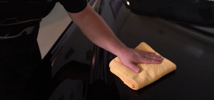 Buffing the surface with a cleansed, dry microfiber towel.