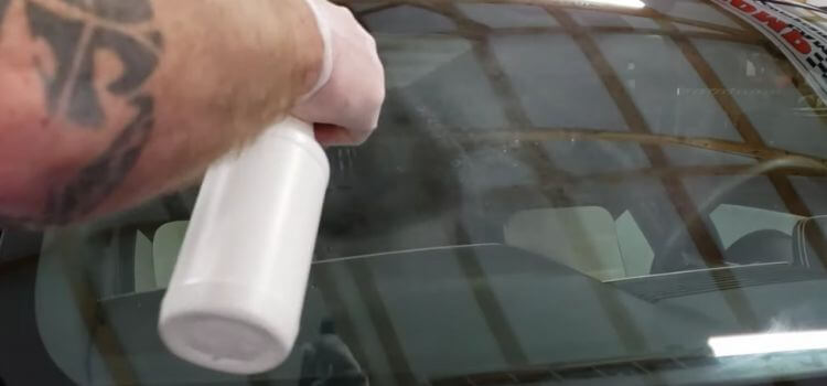 Use a solution of vinegar and water to scrub the windshield.