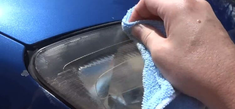 You can remove the product with a clean cloth once the product has dried to a haze.